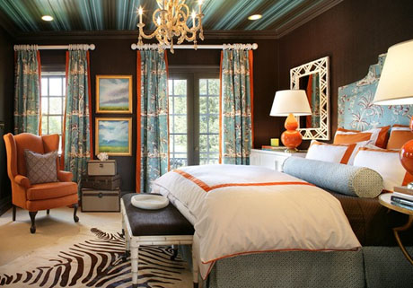 This bedroom design uses the blue on the walls and accents with orange ...